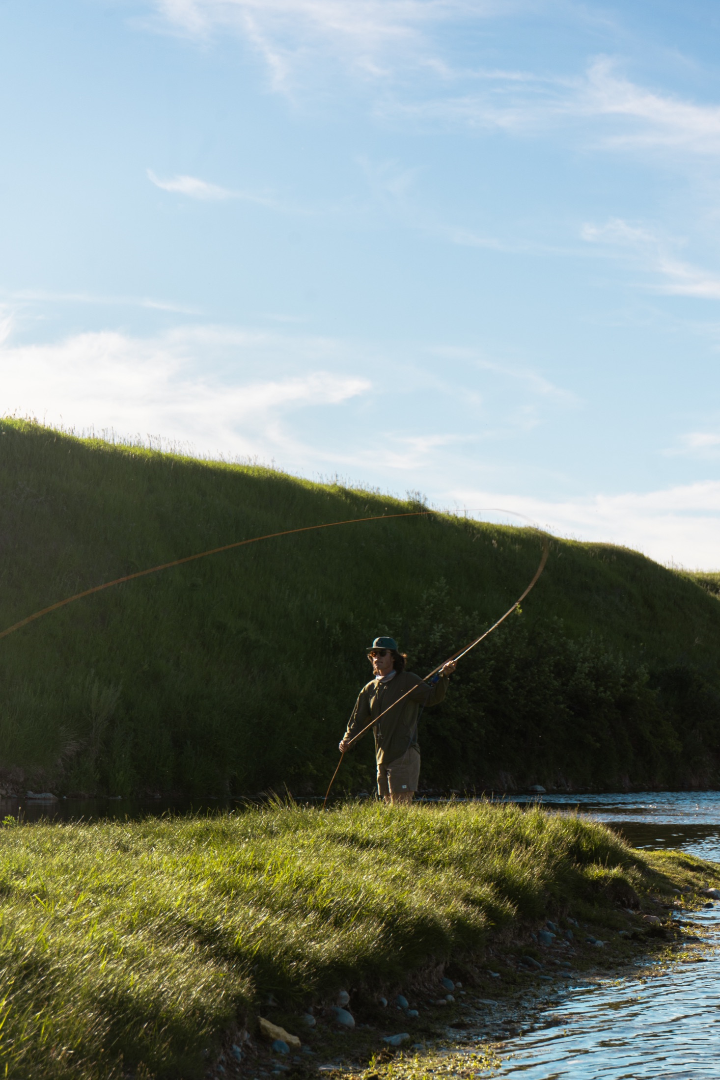 A guest fly fishing on the river at a Refuge property